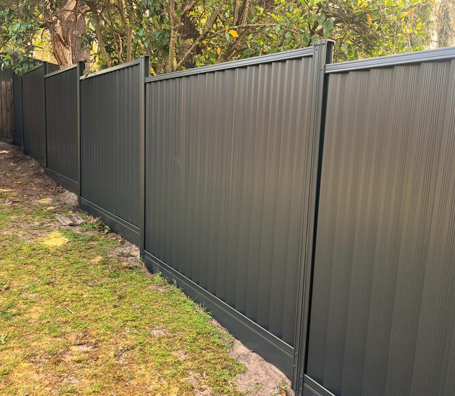 Zig zag Colorbond fence on sloping ground with aluminium sleepers in Cranbourne Eas